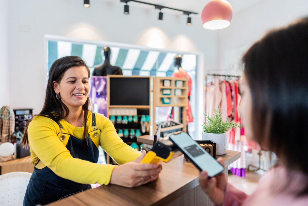 Customer paying using smartphone in a thrift store