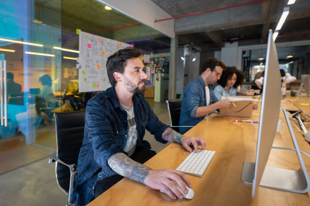 Designer working at a creative office using his desktop computer