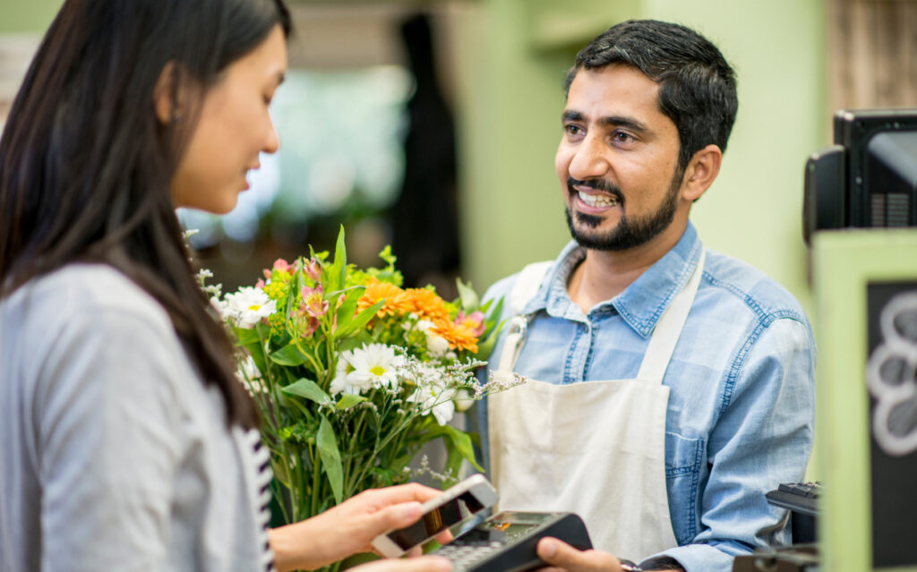 business owner allowing a customer to swipe her credit card