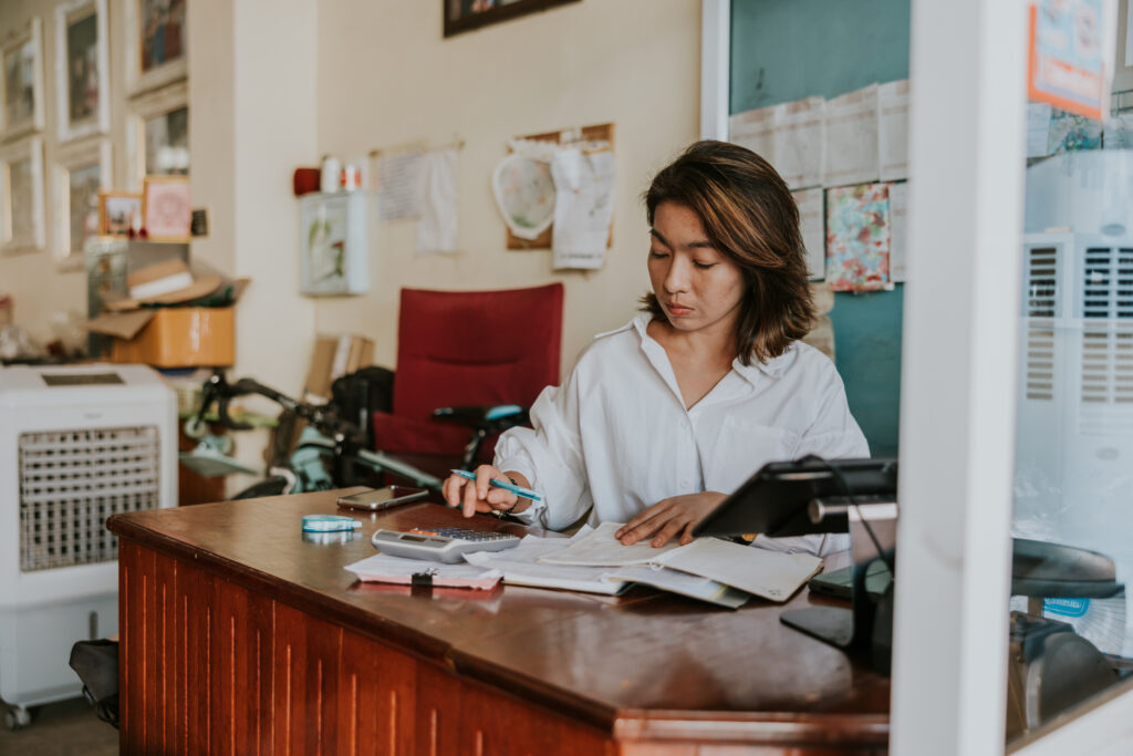 owner at her small local business, working with financial planning