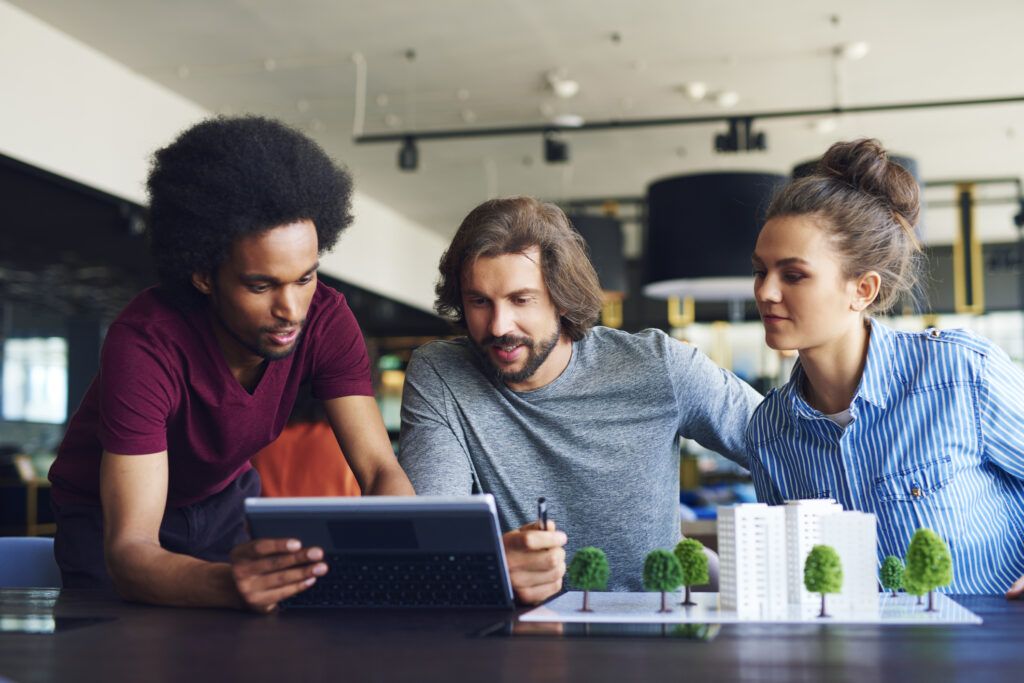 Young adult colleagues working at office desk